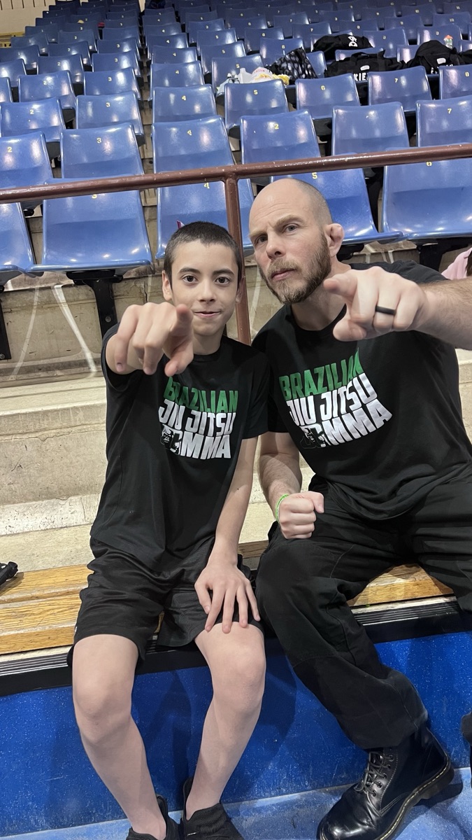 Patrick at a Jiu-Jitsu tournament with his son